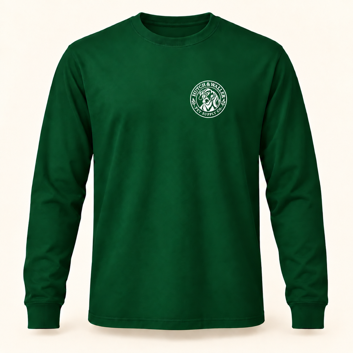 Hutch & Waller Classic Badge Long-Sleeve Tee in Forest, white single-color left-chest badge, revised mockup